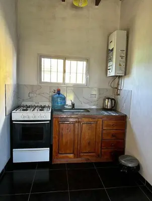 a kitchen with a stove and a sink at Casa WIWI in La Estancia
