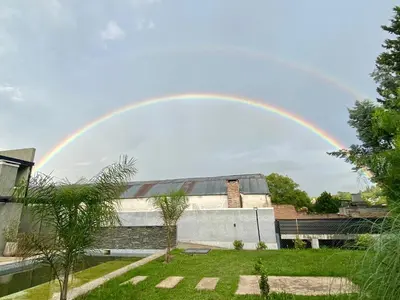 a rainbow in the sky over a building at Magdalena in Santa Rosa de Calamuchita