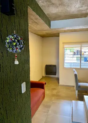 a living room with a couch and a window at Magdalena in Santa Rosa de Calamuchita