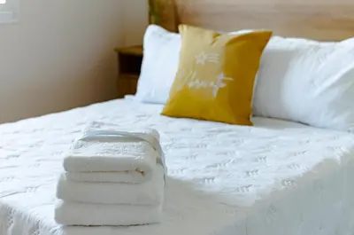 a pile of towels sitting on a bed at TempoHome in Cordoba