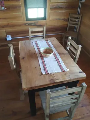 a wooden table with chairs and a bowl of food on it at La Eugelina in Santa Rosa de Calamuchita