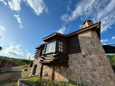 a building with a window on the side of it at Cabaña Ari in Villa Santa Cruz del Lago