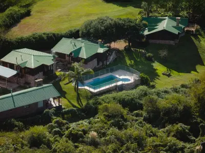 an aerial view of a house with a swimming pool at Cabaña Ari in Villa Santa Cruz del Lago