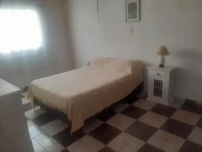 a bedroom with a bed and a table and a window at Posada clara in Cordoba