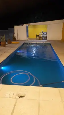 a swimming pool at night with blue lights in it at Posada clara in Cordoba