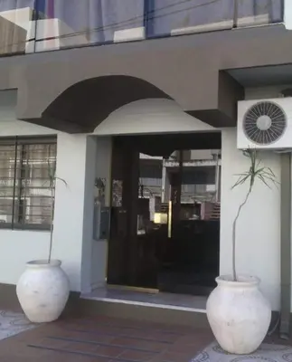 two large vases sitting in front of a building at Alquiler de departamento céntrico en Villa Carlos Paz in Villa Carlos Paz