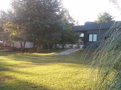 a house with a grassy yard in front of a house at Casitas del Lago in Potrero de Garay
