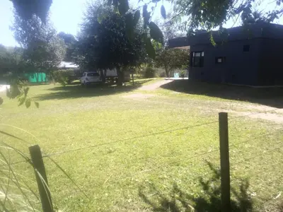 a yard with a house and a fence at Casitas del Lago in Potrero de Garay