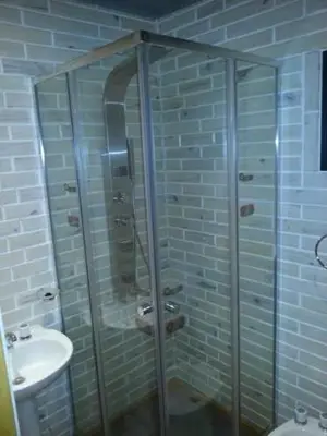 a bathroom with a shower and a toilet and a sink at Casitas del Lago in Potrero de Garay