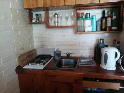 a kitchen counter with a sink and a stove at Casitas del Lago in Potrero de Garay