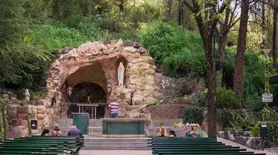 a group of people sitting around a fountain in a park at Flor del Aromito in Alta Gracia