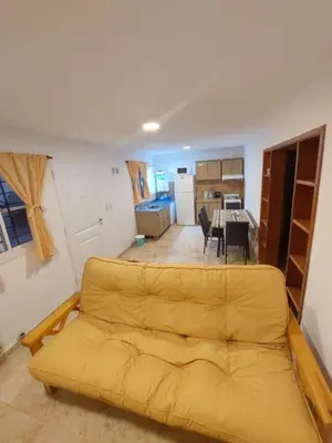 a living room with a yellow couch in a room at Flor del Aromito in Alta Gracia