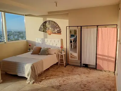 a bedroom with a large bed and a balcony at Candy House - Céntrico - Fabuloso - Seguridad 24 hs - Vista Insuperable in Cordoba