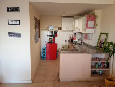 a kitchen with white cabinets and a red refrigerator at Candy House - Céntrico - Fabuloso - Seguridad 24 hs - Vista Insuperable in Cordoba