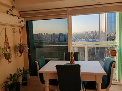 a dining room with a table and a large window at Candy House - Céntrico - Fabuloso - Seguridad 24 hs - Vista Insuperable in Cordoba