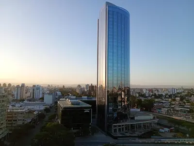 a tall skyscraper with a city in the background at Candy House - Céntrico - Fabuloso - Seguridad 24 hs - Vista Insuperable in Cordoba