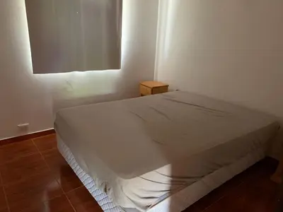 a white bed in a room with a window at Apartamentos Dorothy in Villa Santa Cruz del Lago