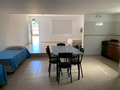 a room with a table and chairs and a bedroom at Apartamentos Dorothy in Villa Santa Cruz del Lago