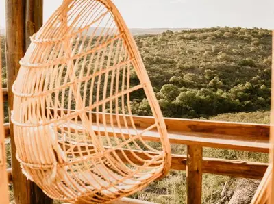 a rattan chair sitting on top of a balcony at Aldea Romerillo in Cavalango