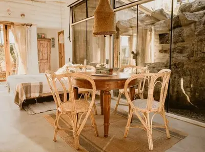 a dining room with a wooden table and chairs at Aldea Romerillo in Cavalango
