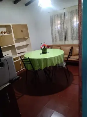 a room with a table with a vase of flowers on it at Mirando sierra in Bialet Massé