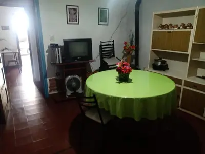 a room with a green table with a vase of flowers on it at Mirando sierra in Bialet Massé