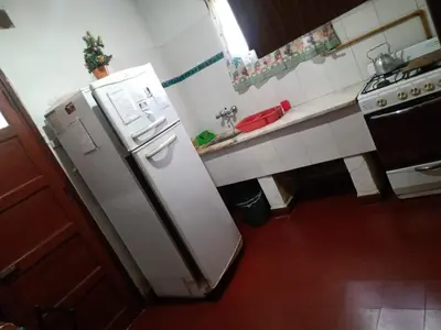 a kitchen with a white refrigerator and a sink at Mirando sierra in Bialet Massé