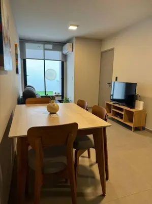 a dining room with a table and chairs and a television at Alquiler Ituzaingo 665 in Cordoba