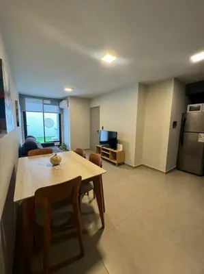 a room with a table and chairs and a kitchen at Alquiler Ituzaingo 665 in Cordoba