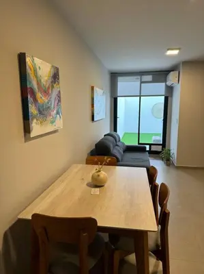 a living room with a wooden table and a couch at Alquiler Ituzaingo 665 in Cordoba