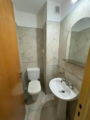 a small bathroom with a toilet and a sink at Departamento 2 dormitorios in Cordoba