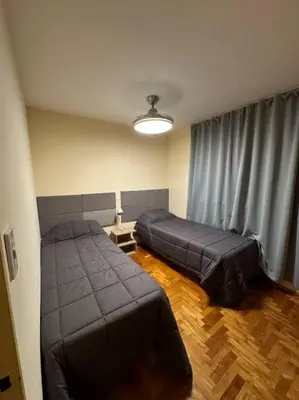 a bedroom with two beds and a window at Departamento 2 dormitorios in Cordoba