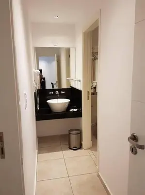 a bathroom with a sink and a mirror at Amérian Carlos Paz Depto Particular 108 in Villa Carlos Paz