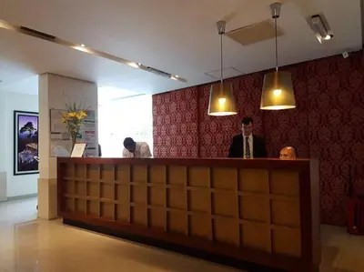 two men standing at a bar in a room at Amérian Carlos Paz Depto Particular 108 in Villa Carlos Paz