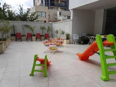 a patio with colorful chairs and tables and chairs at Amérian Carlos Paz Depto Particular 108 in Villa Carlos Paz