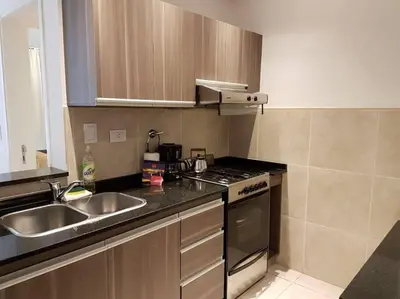 a kitchen with a sink and a stove at Amérian Carlos Paz Depto Particular 108 in Villa Carlos Paz