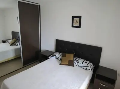 a bedroom with a bed and a large mirror at TEMPO Departamento 43 in Villa Carlos Paz