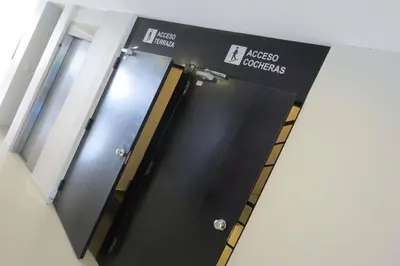 a row of elevator doors in a building at TEMPO Departamento 43 in Villa Carlos Paz