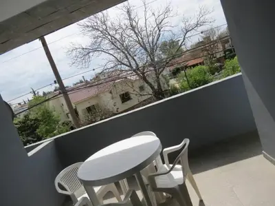 a white table and chairs on a balcony at TEMPO Departamento 43 in Villa Carlos Paz