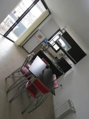 an aerial view of a kitchen with a red chair at TEMPO Departamento 43 in Villa Carlos Paz