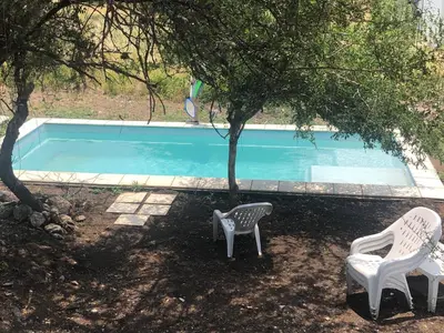 two chairs sitting next to a swimming pool at Terra Bella in San Antonio de Arredondo