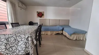 a bedroom with a bed and a table with chairs at Terraza Terraza in Villa Carlos Paz