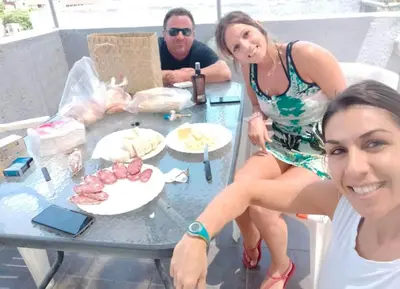a man and a woman sitting at a table with food at Terraza Terraza in Villa Carlos Paz