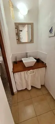 a bathroom with a sink and a mirror at Cabaña en Punilla in Villa Parque Siquiman