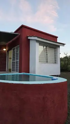 a house with a pool in front of it at Cabaña en Punilla in Villa Parque Siquiman