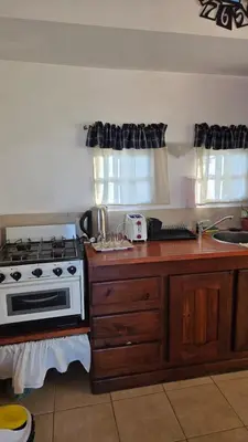 a kitchen with a stove and a counter top at Cabaña en Punilla in Villa Parque Siquiman