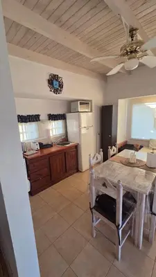 a kitchen with a table and a dining room at Cabaña en Punilla in Villa Parque Siquiman