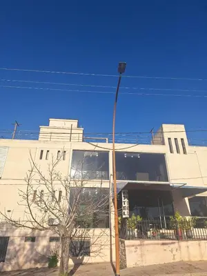 a building with a street light in front of it at El Redentor in Villa Carlos Paz