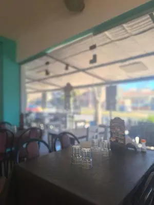 a table in a restaurant with glasses on it at El Redentor in Villa Carlos Paz