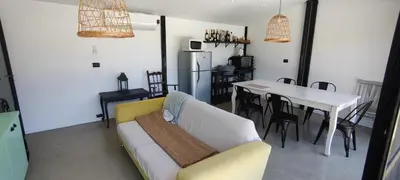 a living room with a couch and a table at Alquiler Casa Exclusivo Country Causana 6 Personas en Villa Carlos Paz in Villa Carlos Paz